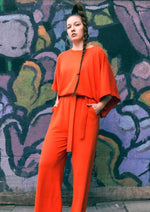 Lataa kuva Galleria-katseluun, Oranssin värinen jumpsuit alas lasketuilla hihoilla.